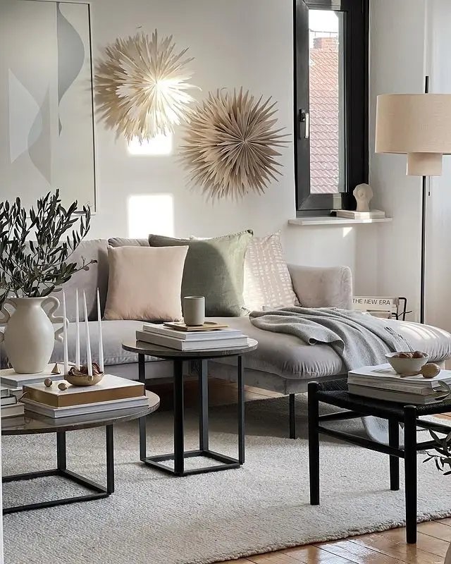 living space with a neutral color palette showcasing throw pillows and blankets on a sectional ideal for winter decor