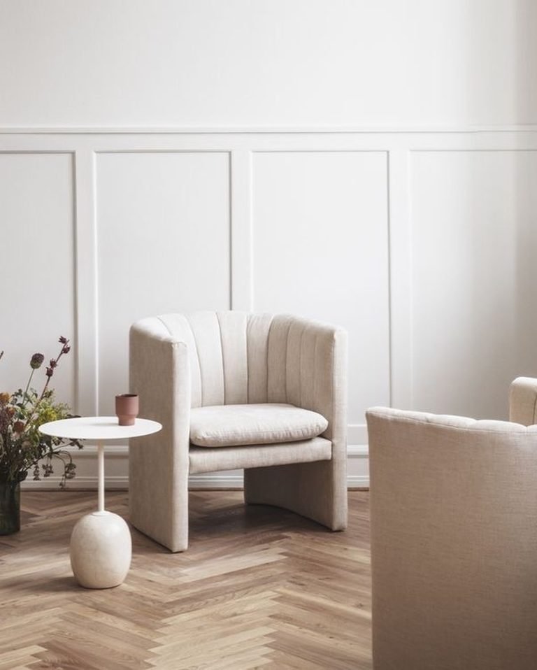 it's important to choose and pair a small side table to a sofa in order to complement the overall decor of a living room rather than to compete with it.