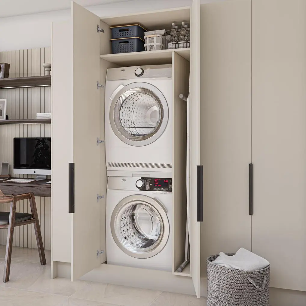 stackable washer and dryer inside a closet with the door opened is a great way to add a laundry closet next to any space within the home like in this example next to a workspace
